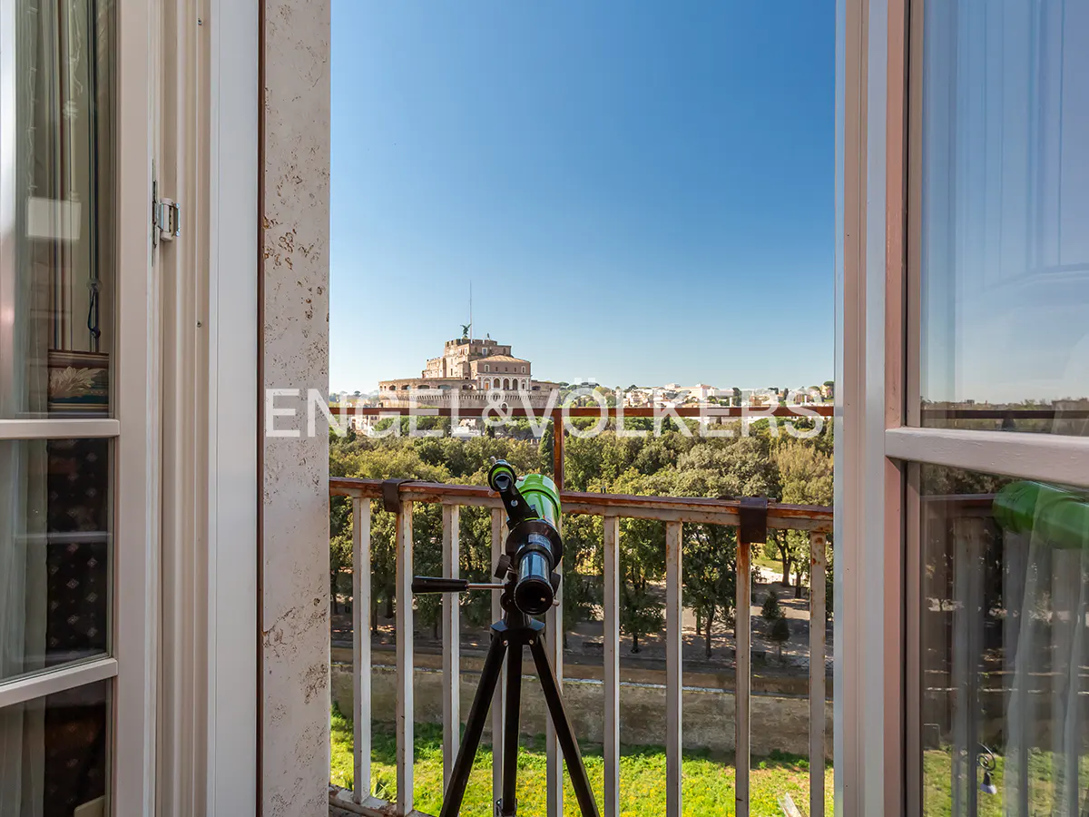 View from a balcony with a telescope pointed at Castel Sant'Angelo in Rome, Italy, on a clear day.
