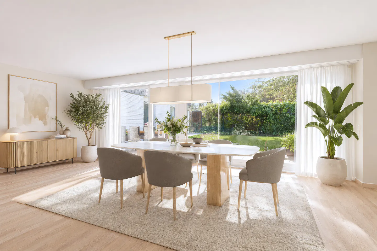 Bright dining room with a marble table, six gray chairs, and a light wood floor. Large windows overlook a green garden.