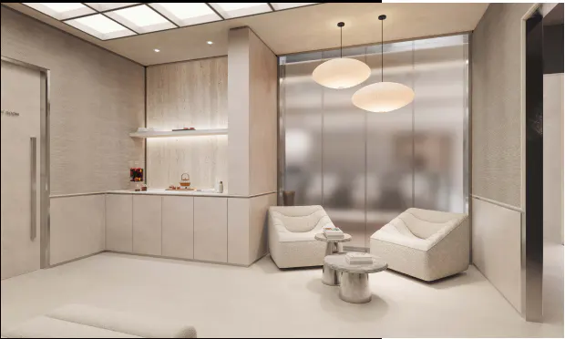 Modern lounge with two cream armchairs, small stone tables, pendant lights, and a minimalist built-in cabinet in beige.
