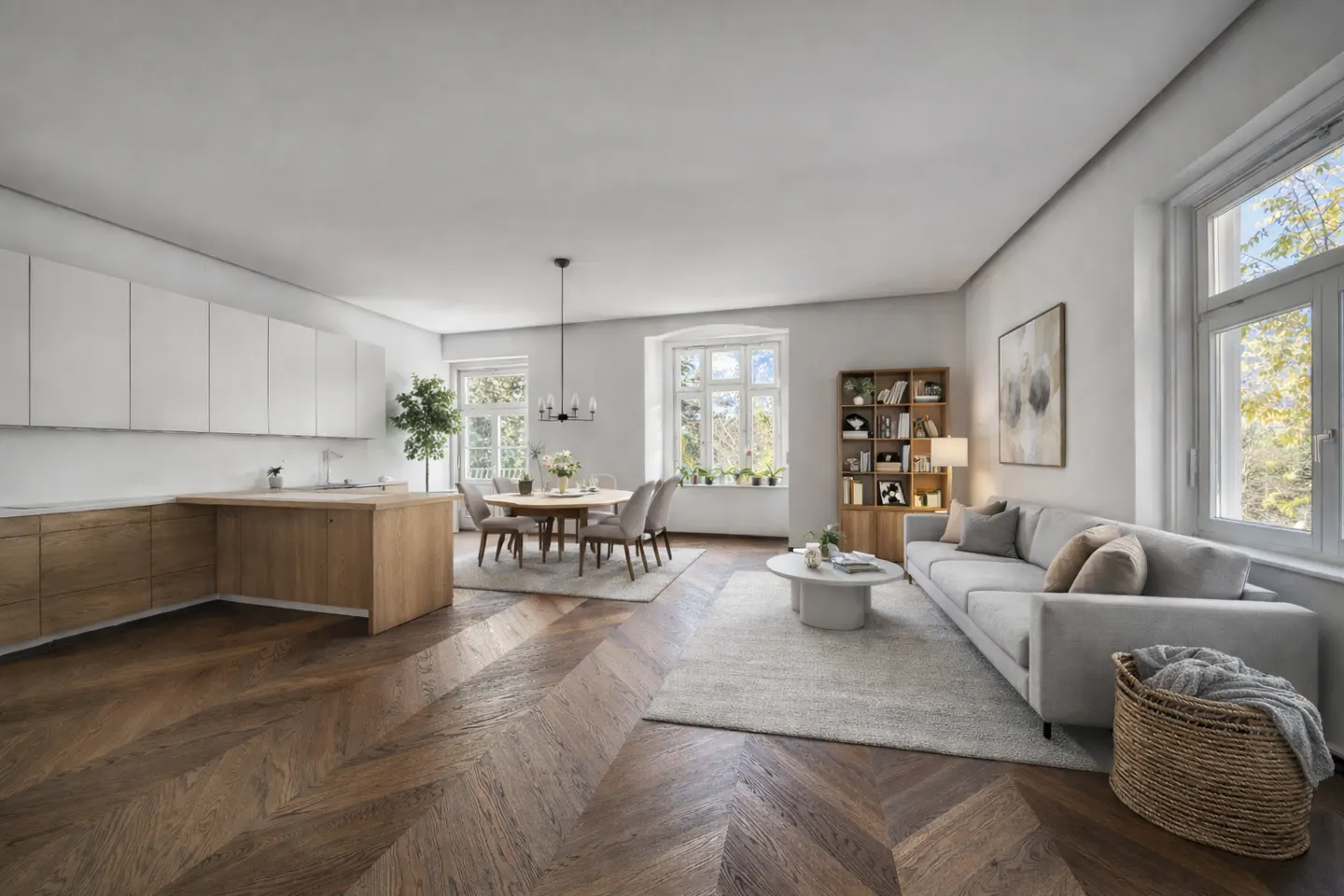 Open-plan living area with light wood kitchen, dining table, grey sofa, and chevron-patterned hardwood floors.