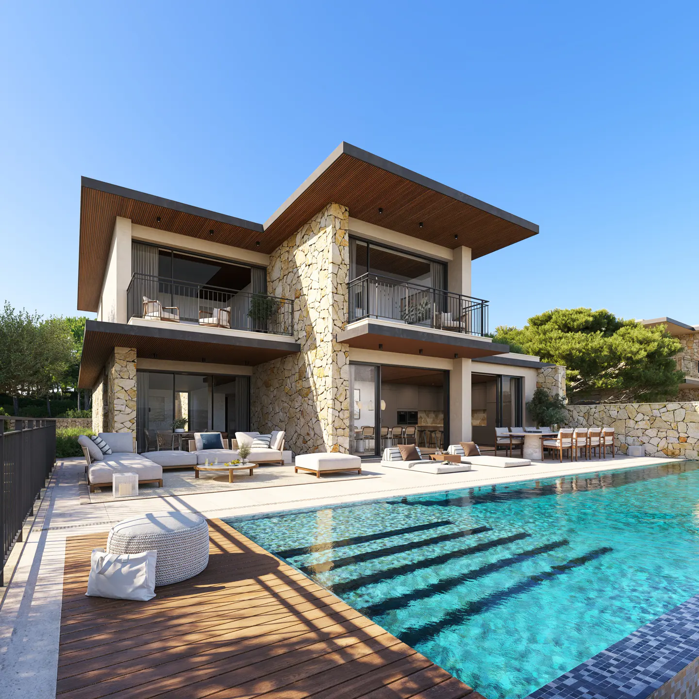 Two-story house with stone accents, balconies, and a pool with steps. Outdoor furniture is visible. Blue sky.