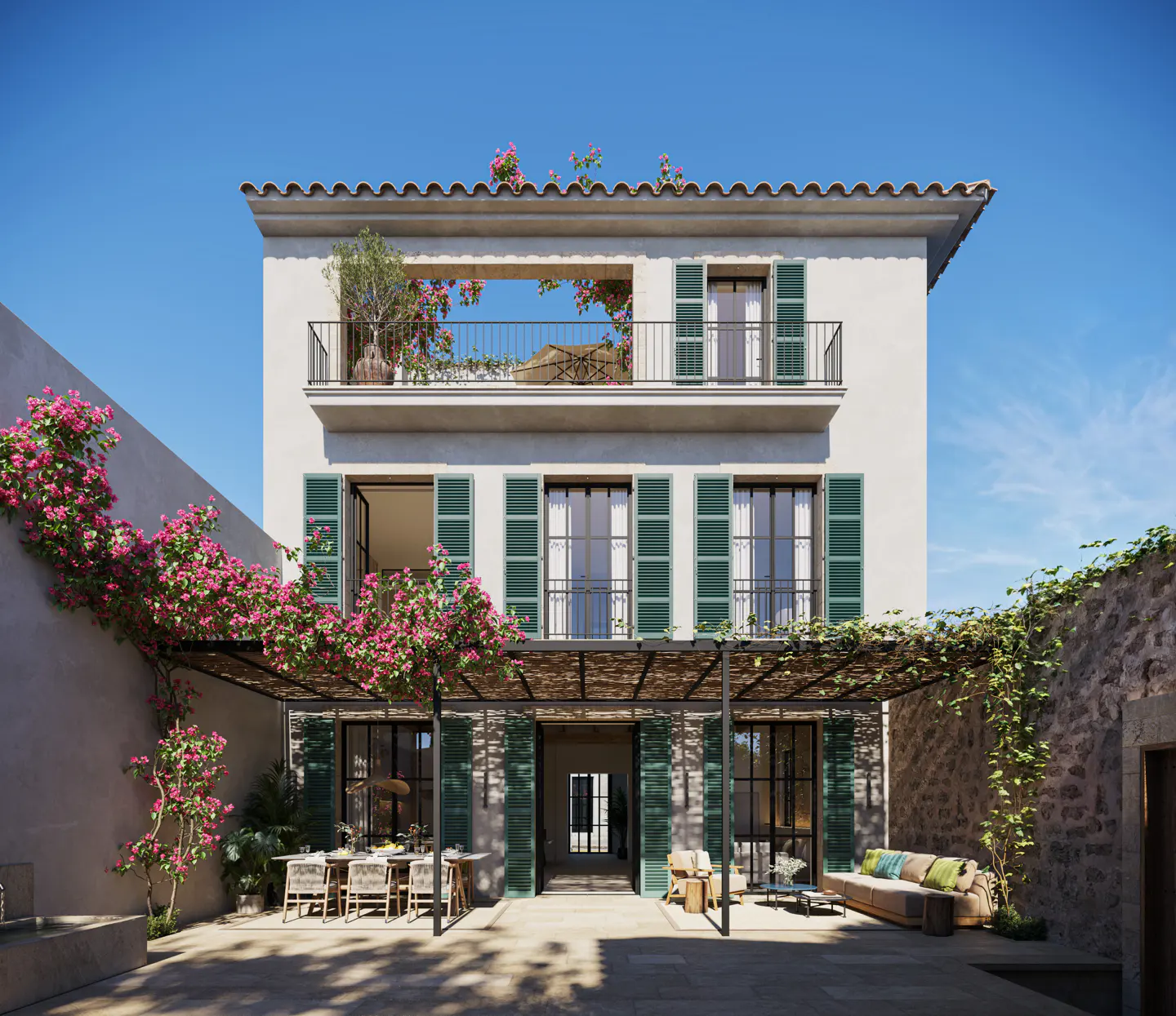 Two-story white house with green shutters, a balcony, and a pergola covered in pink flowers. Outdoor dining and seating areas are visible.