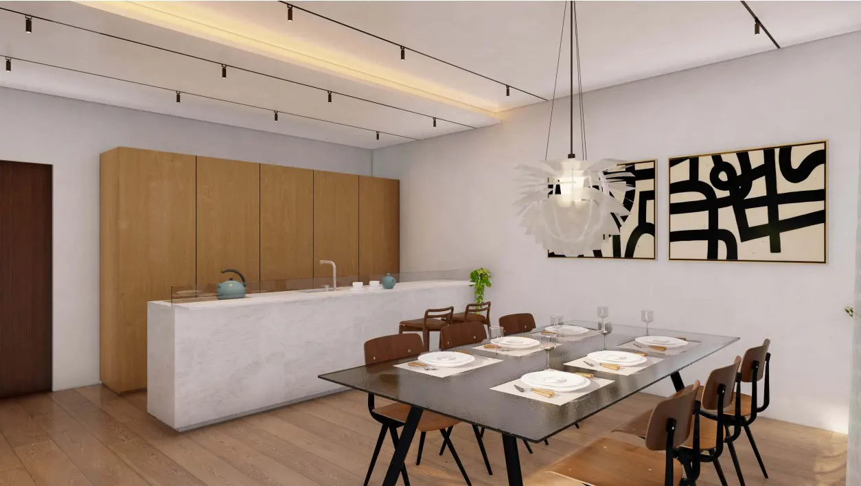 A modern dining area with a black table set for six, surrounded by wooden chairs. Abstract art hangs on the white wall, lit by a pendant lamp. A kitchen island and cabinets are in the background.