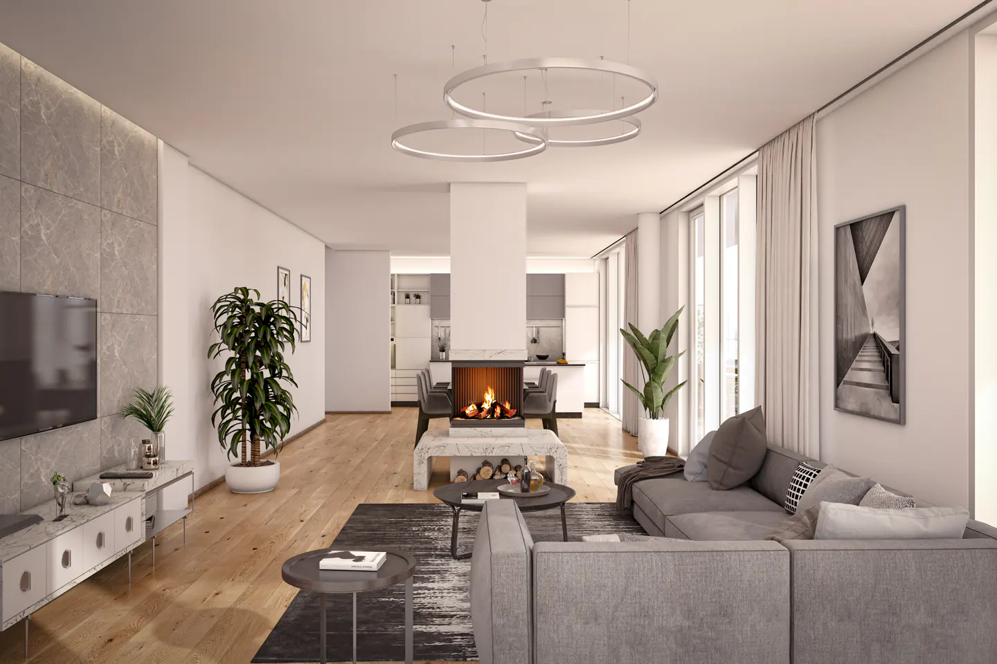A modern living room with a gray sofa, fireplace, and open kitchen. Round, white pendant lights hang from the ceiling. A black and white photo hangs on the wall.