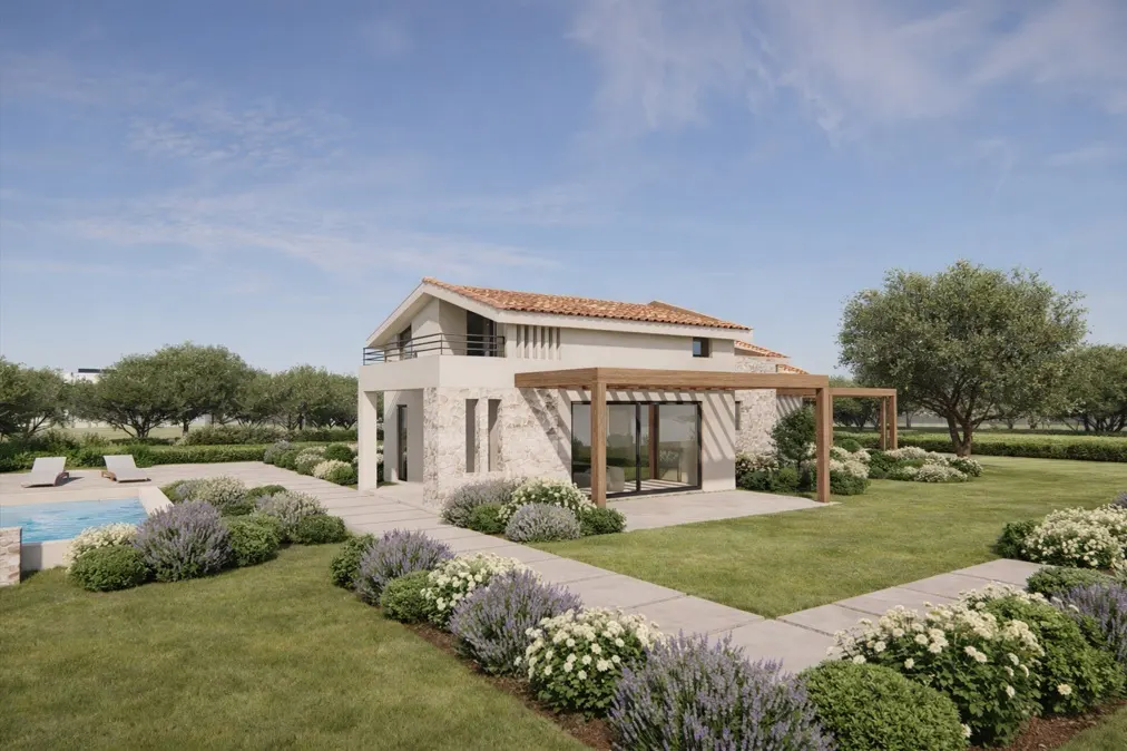 Exterior view of a two-story house with a red tile roof, stone facade, and a pergola, surrounded by a green lawn, lavender bushes, and a pool.