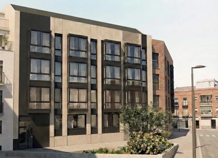 Exterior view of a modern apartment building with large windows and a mix of brick and concrete facade.
