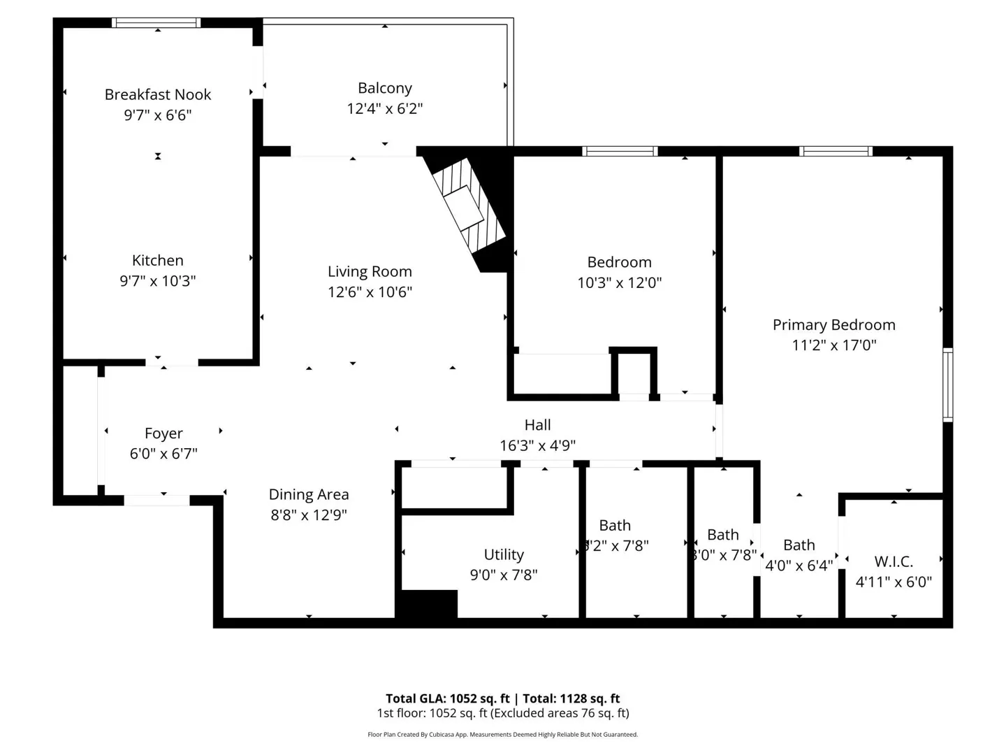 Black and white floor plan of a one-story house with a kitchen, living room, and two bedrooms. The total area is 1052 sq ft.