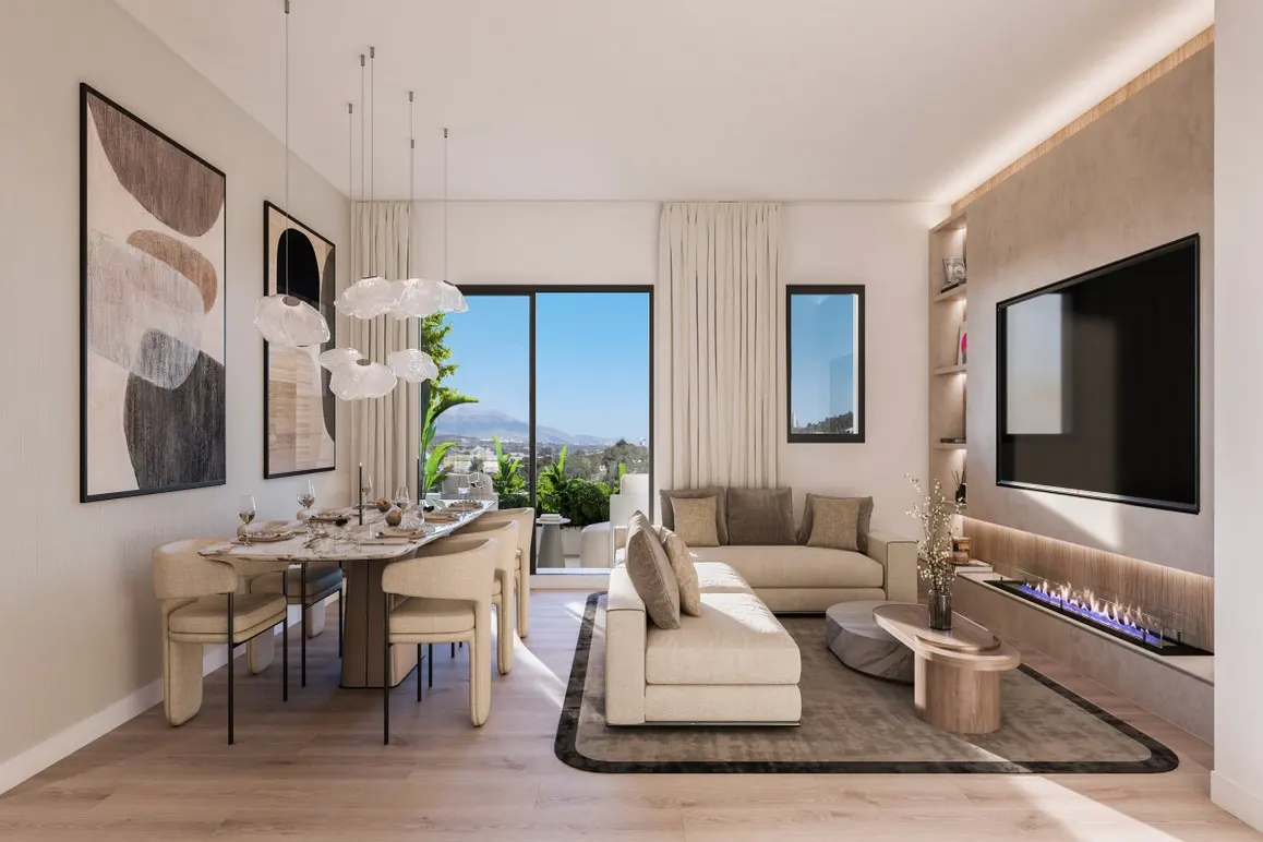 Bright, modern living room with dining table, sofas, and TV. Large windows offer a view of a sunny landscape. Neutral color palette.