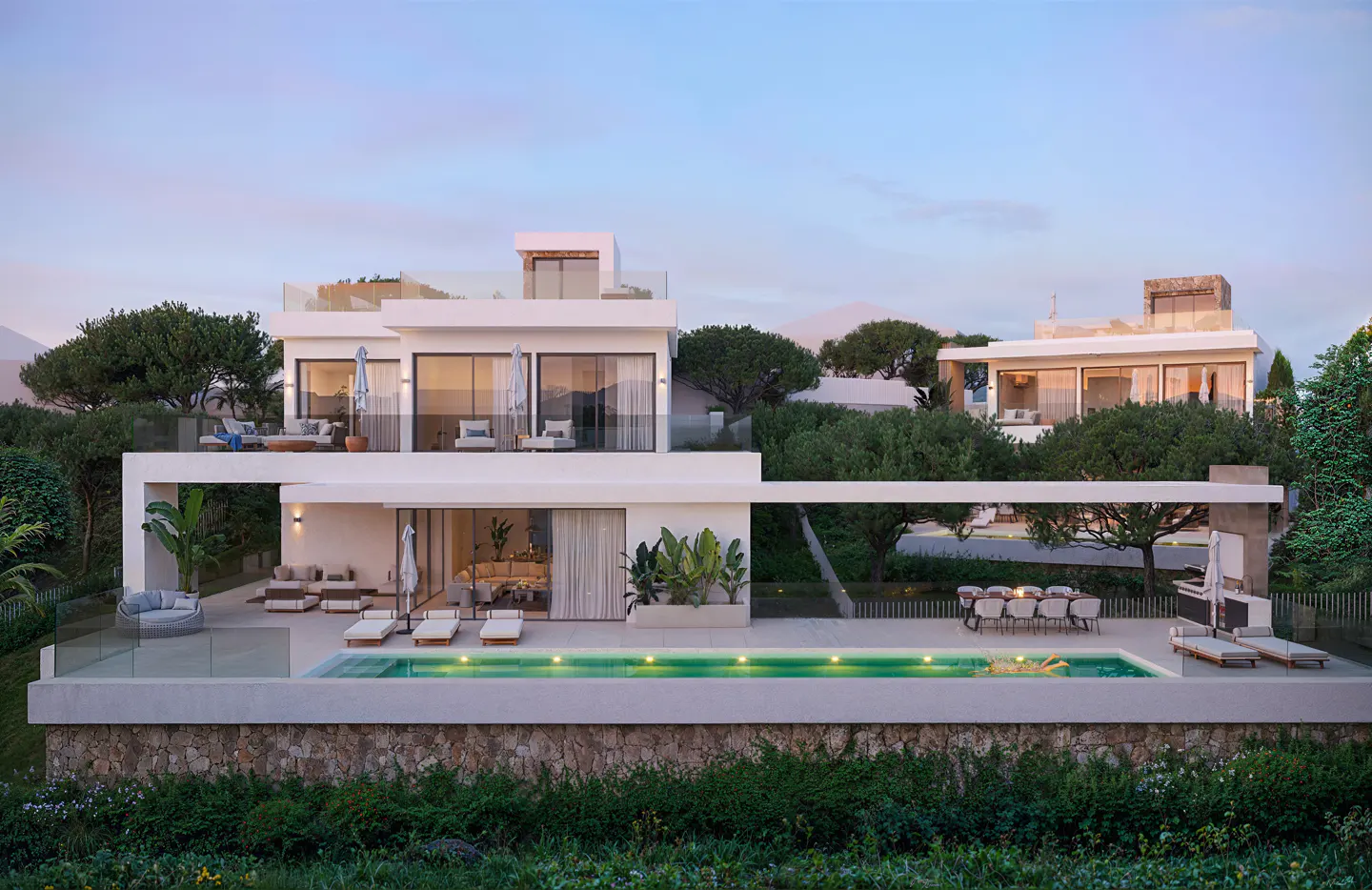 Modern white house with a pool, lounge chairs, and outdoor dining. Lush greenery surrounds the property.