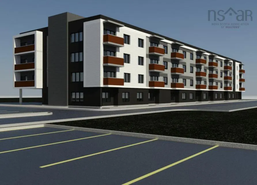 A modern, three-story apartment building with brown balconies and a parking lot.