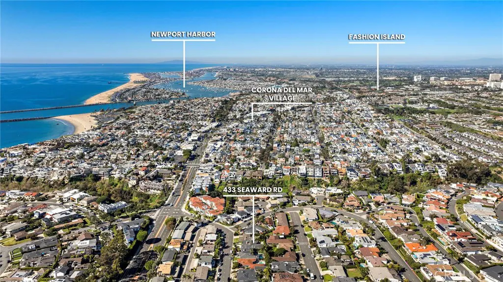 Aerial view of Corona del Mar Village, California, with Newport Harbor, Fashion Island, and 433 Seaward Rd visible. Blue ocean and clear sky.