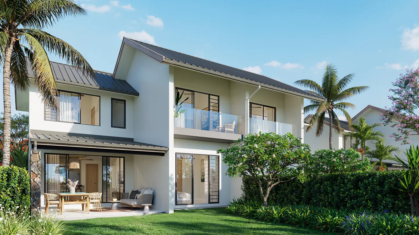 Two-story white house with a dark roof, balcony, and patio with furniture, surrounded by green lawn, trees, and palm trees under a blue sky.