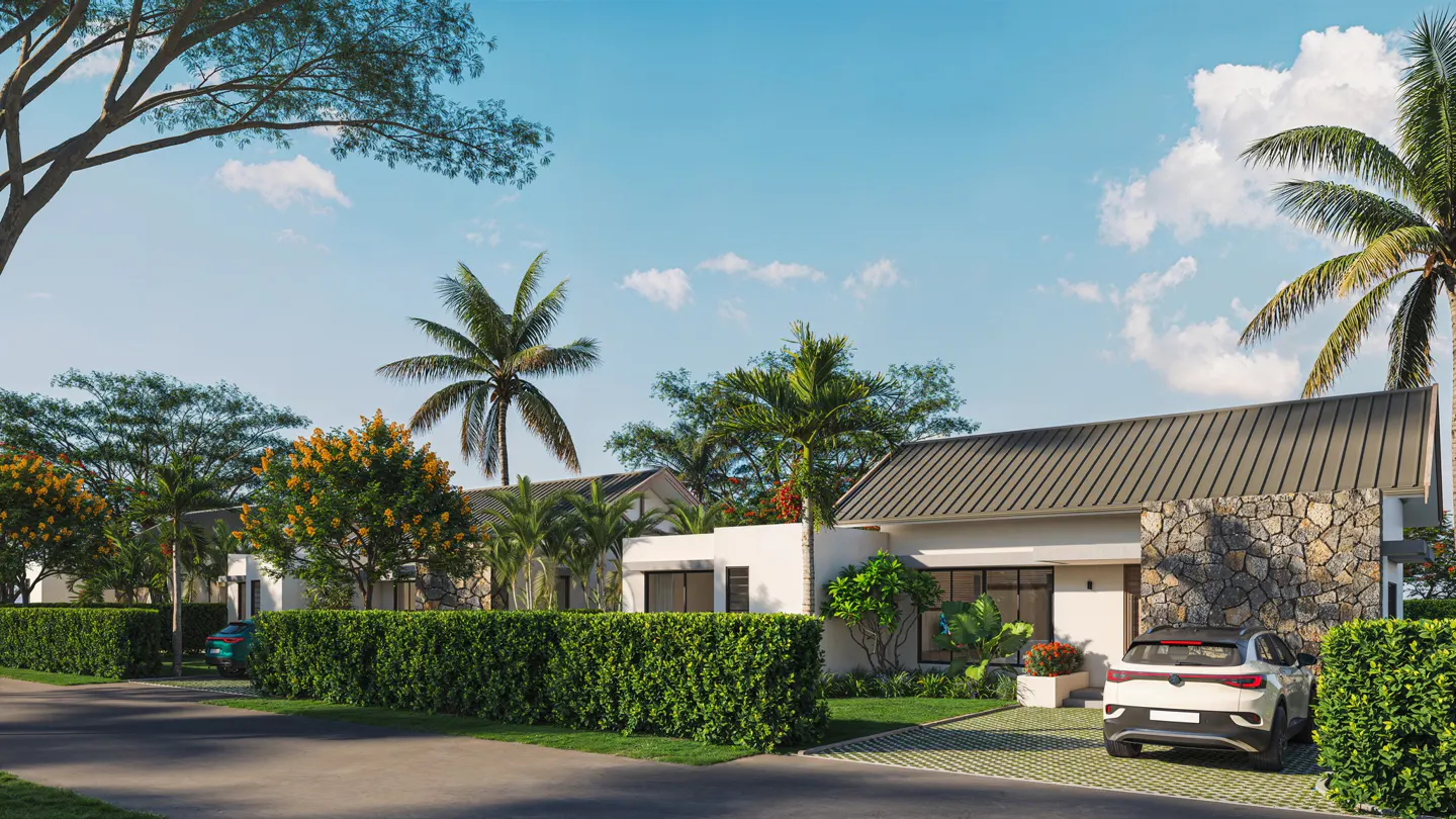 A modern, single-story home with a stone accent wall and gray roof, surrounded by lush green landscaping and palm trees under a blue sky. A white car is parked in the driveway.