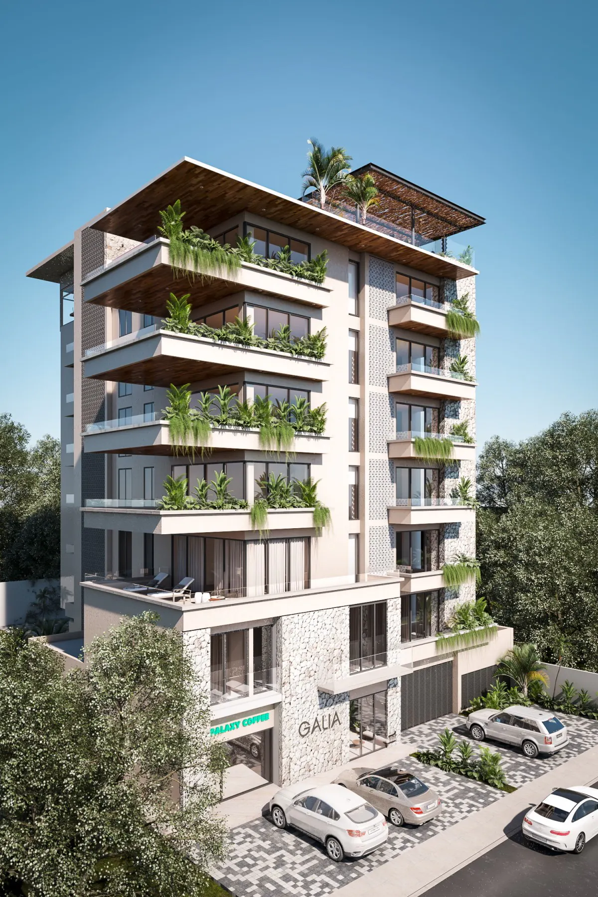 Exterior view of the Galia building, a multi-story residential building with balconies and greenery. Cars are parked in front.