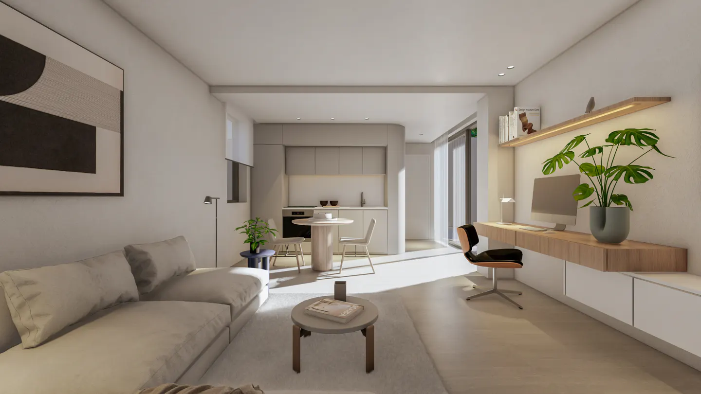 Bright, modern apartment interior with a white sofa, round table, and a desk with a computer and plant. A kitchen area is visible in the background.