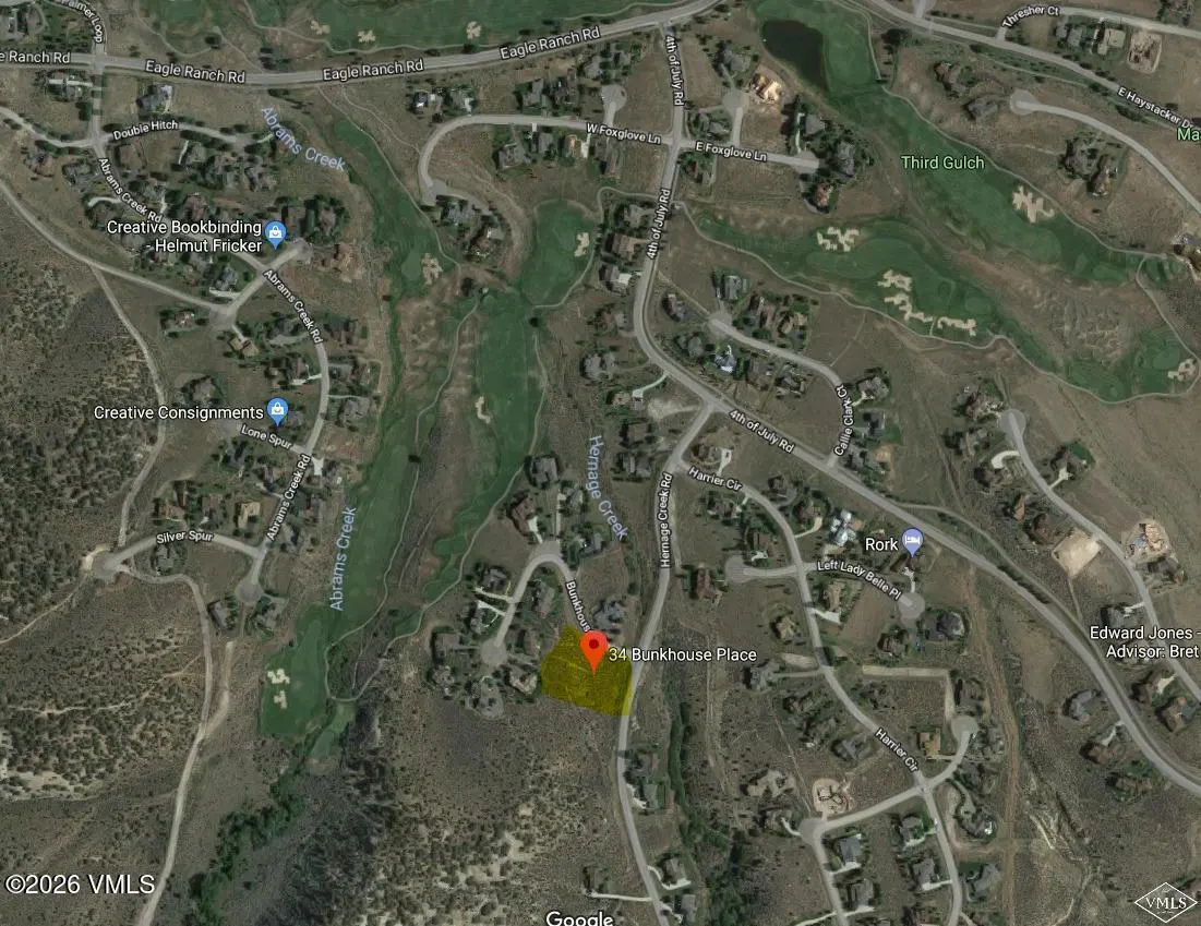 Aerial view of 34 Bunkhouse Place, Eagle, Colorado, surrounded by roads, homes, and a golf course. The property is highlighted in yellow.