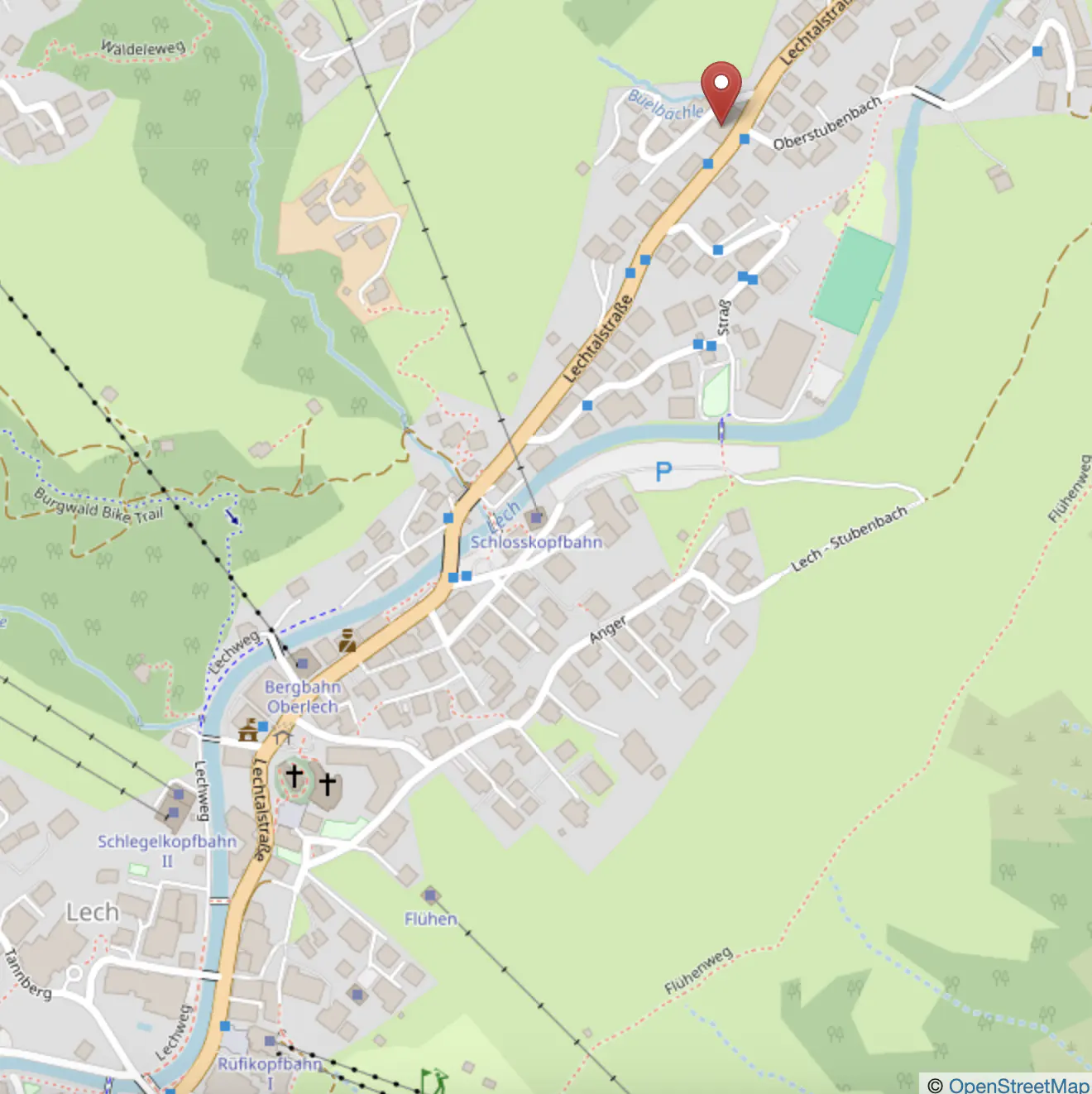 Map of Lech, Austria, showing streets, buildings, and green spaces, with a red pin marking a location.