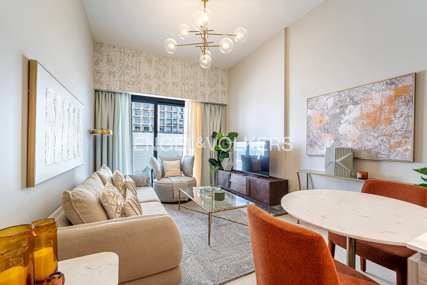 A modern living room with a beige sofa, round chair, glass table, TV, and orange chairs around a white table.