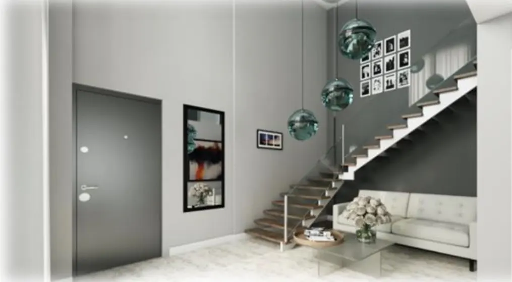 Modern gray entryway with a door, art, stairs, and a white sofa. Three glass pendant lights hang from the ceiling.