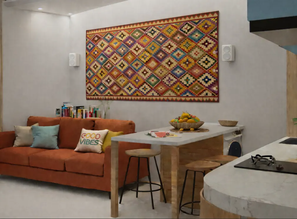 Living room with an orange sofa, a colorful rug on the wall, and a kitchen island with stools.