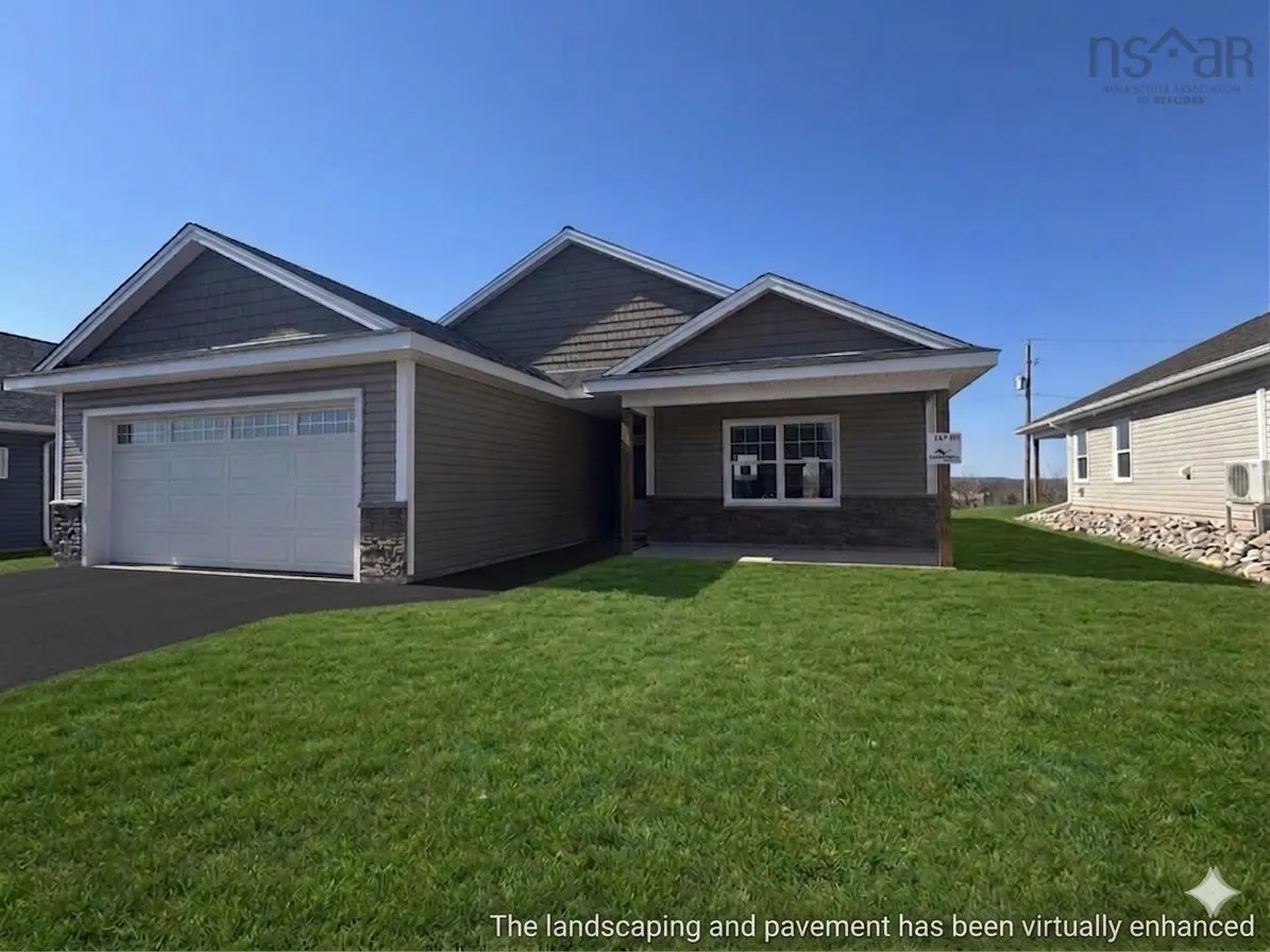 A single-story house with a gray roof, light-brown siding, and a white garage door sits on a green lawn under a blue sky.