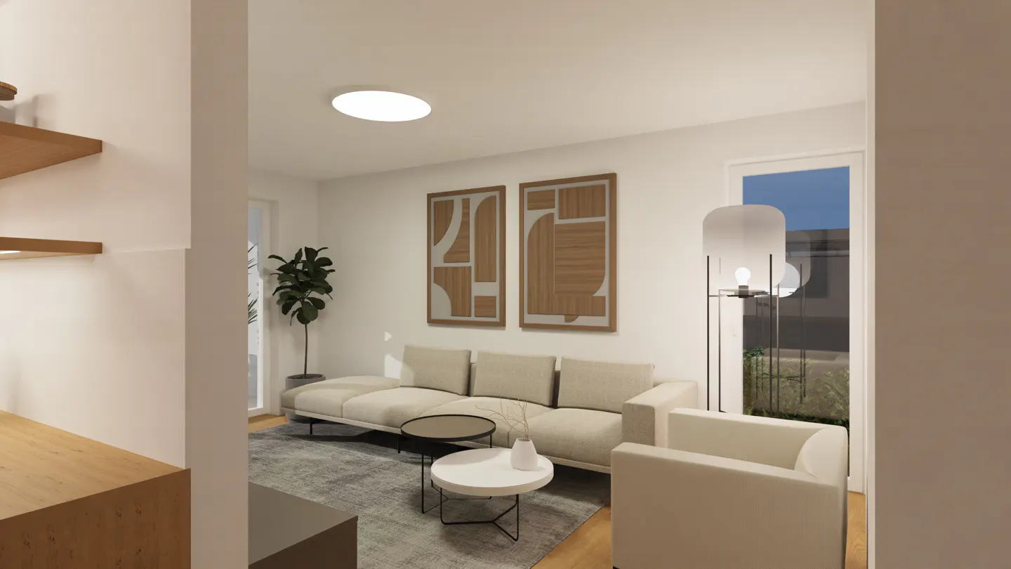 A bright living room with a beige sofa, white armchair, and abstract art. A gray rug covers the floor. A floor lamp stands near a window.