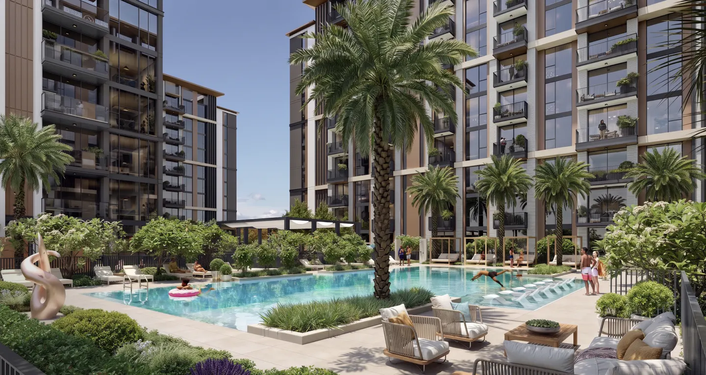Modern apartment complex with a central swimming pool, palm trees, lounge chairs, and people relaxing on a sunny day.