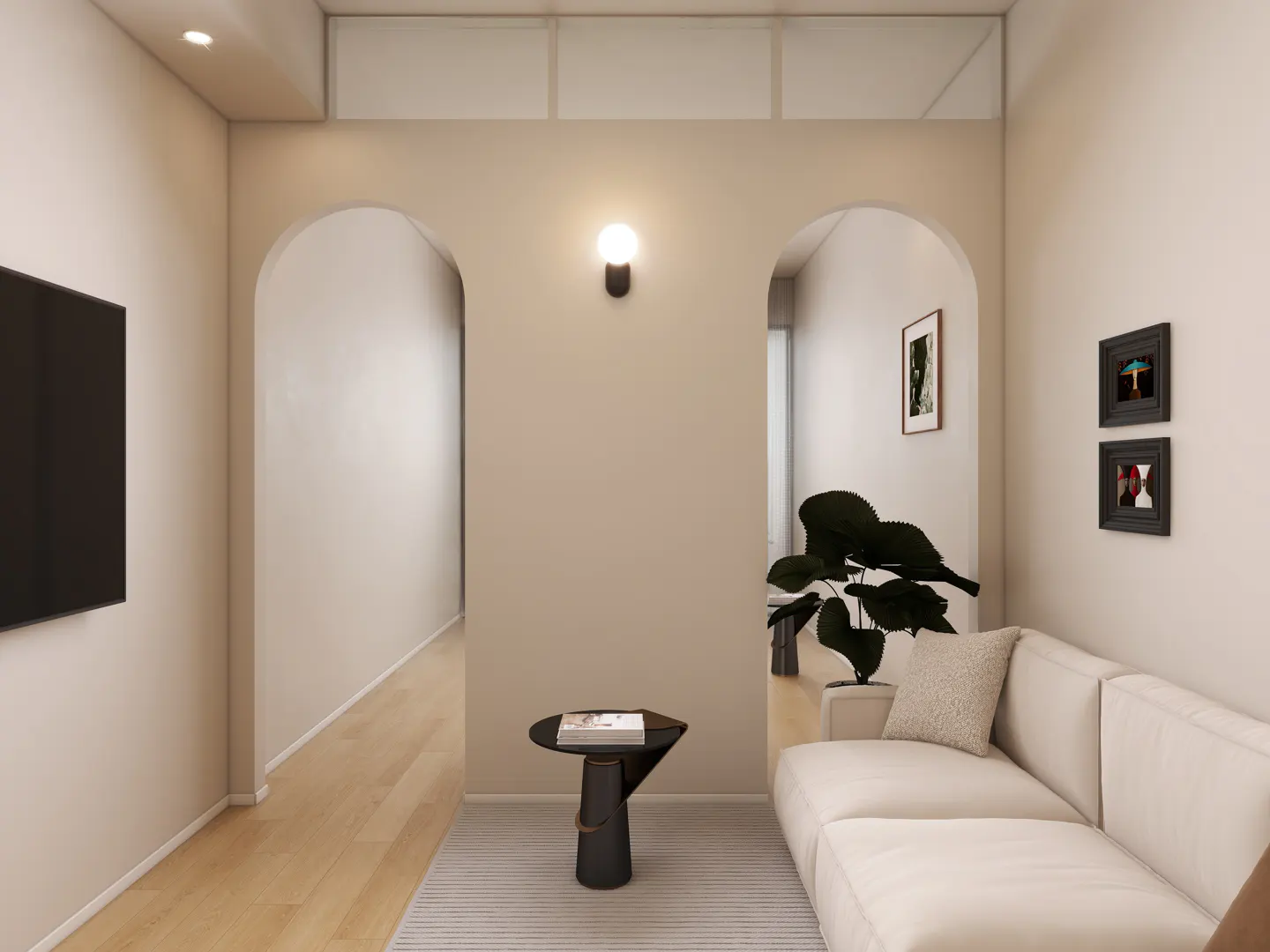 Living room with arched doorways, a white sofa, a black side table, and a plant. Two framed pictures hang on the wall.
