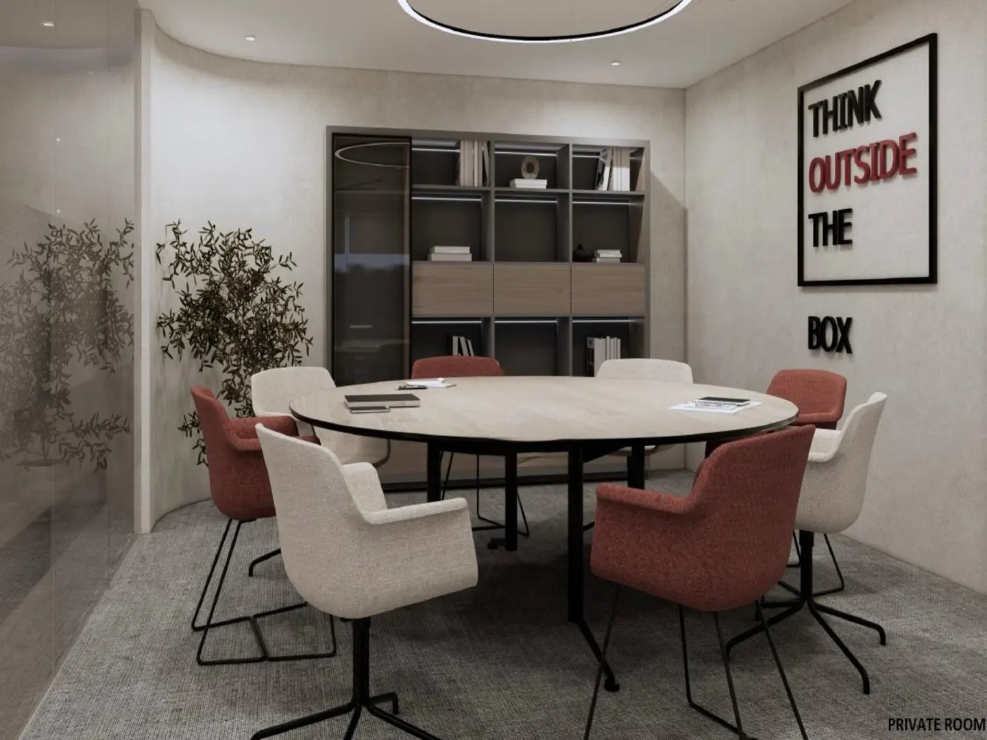 A modern private room with a round table surrounded by beige and red chairs. A bookshelf and a "Think Outside the Box" sign are in the background.