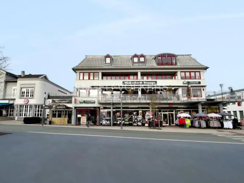 Exterior view of Wackerbarth Passage, a two-story building with shops on the ground floor and apartments above.