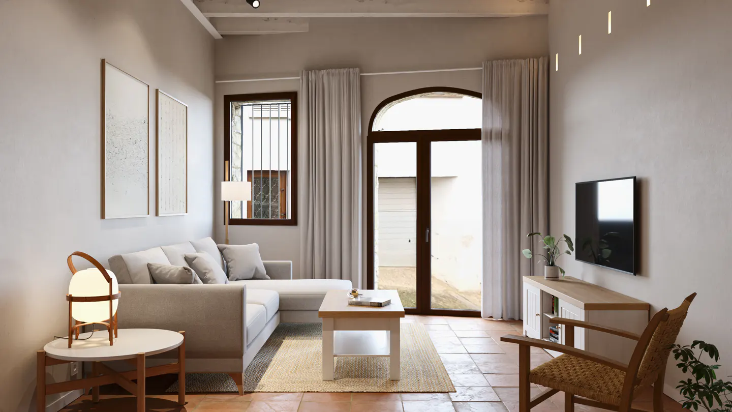 Living room with a gray sectional sofa, white coffee table, and a brown wooden chair. A TV hangs on the wall. Natural light streams through a large arched doorway.