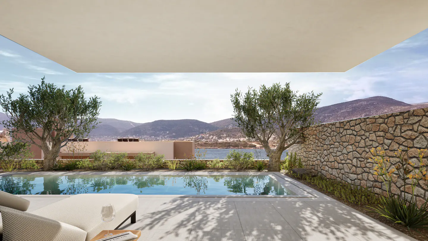 A luxury patio with a swimming pool, stone wall, olive trees, and a scenic view of mountains and water.