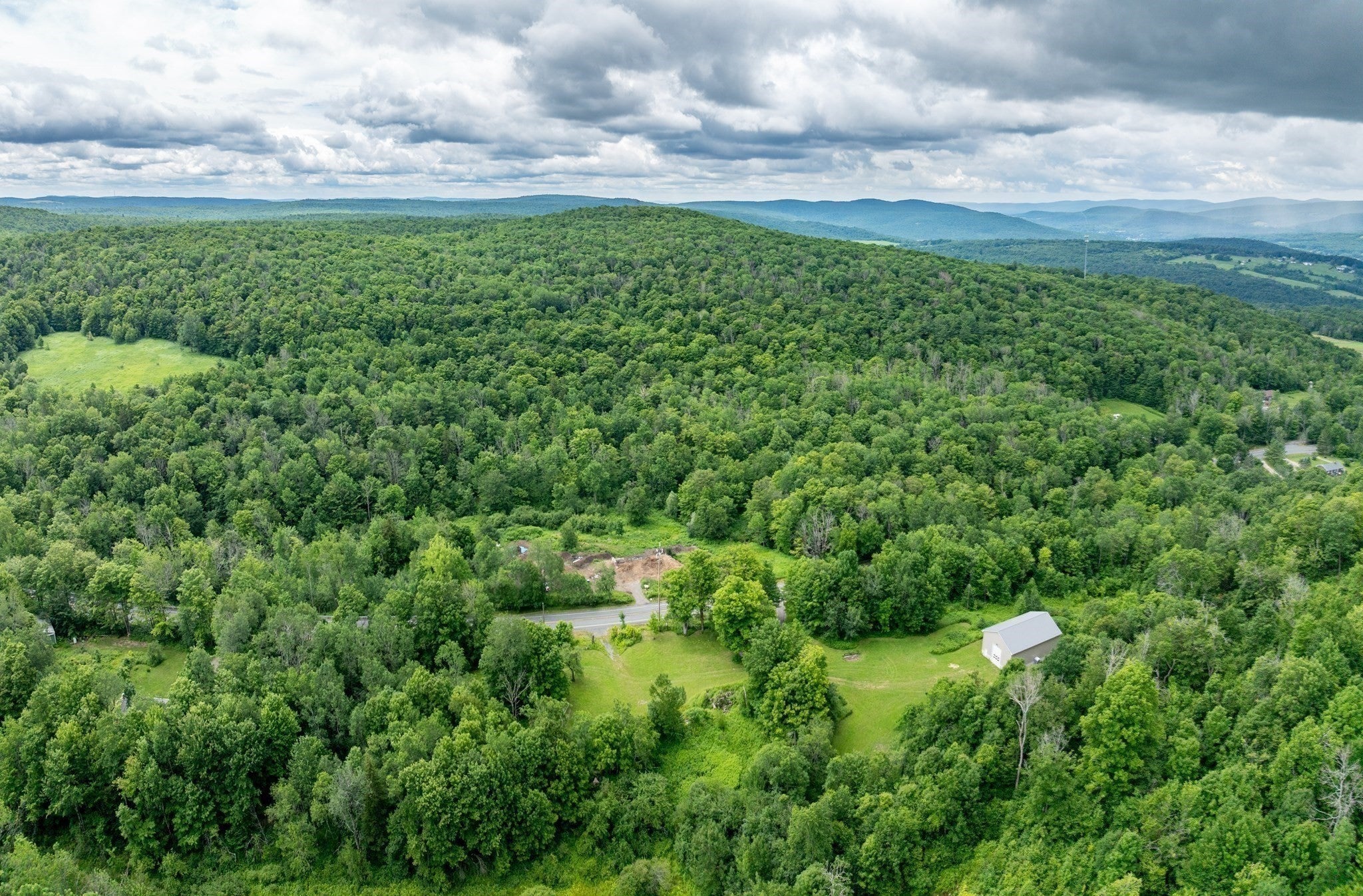 60 acres with commercial type garage and expansive frontage!