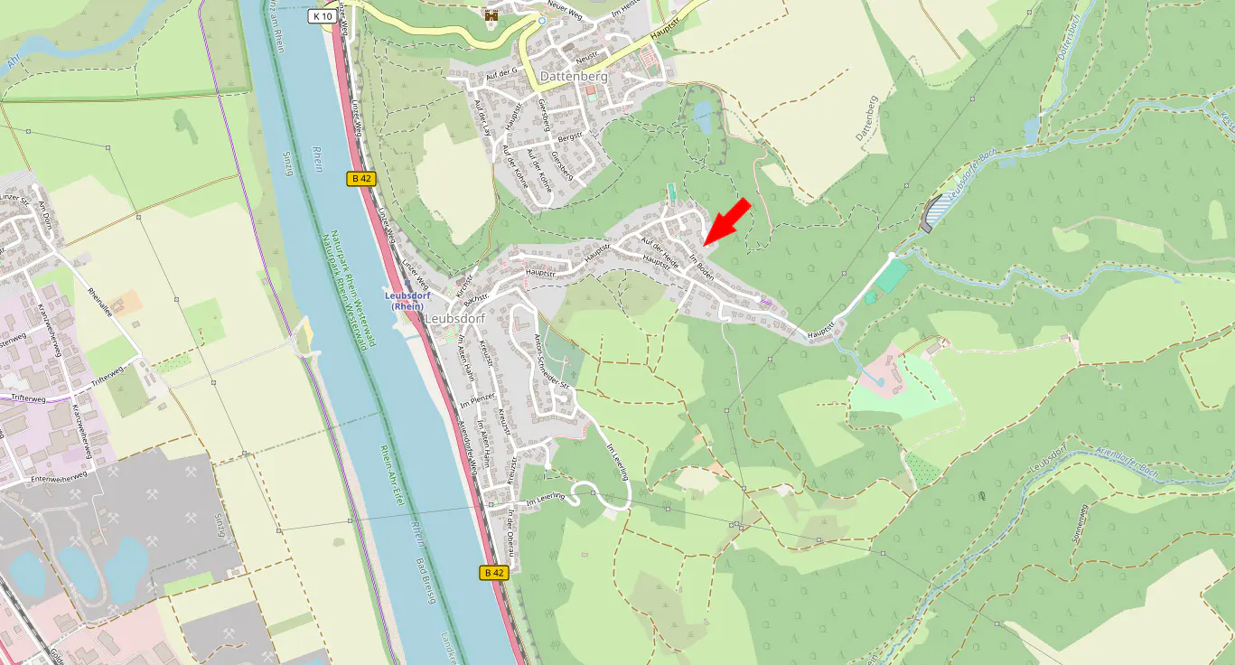 Map view of Leubsdorf, Germany, with a red arrow pointing to a location near a forest. The Rhine River is visible to the west.