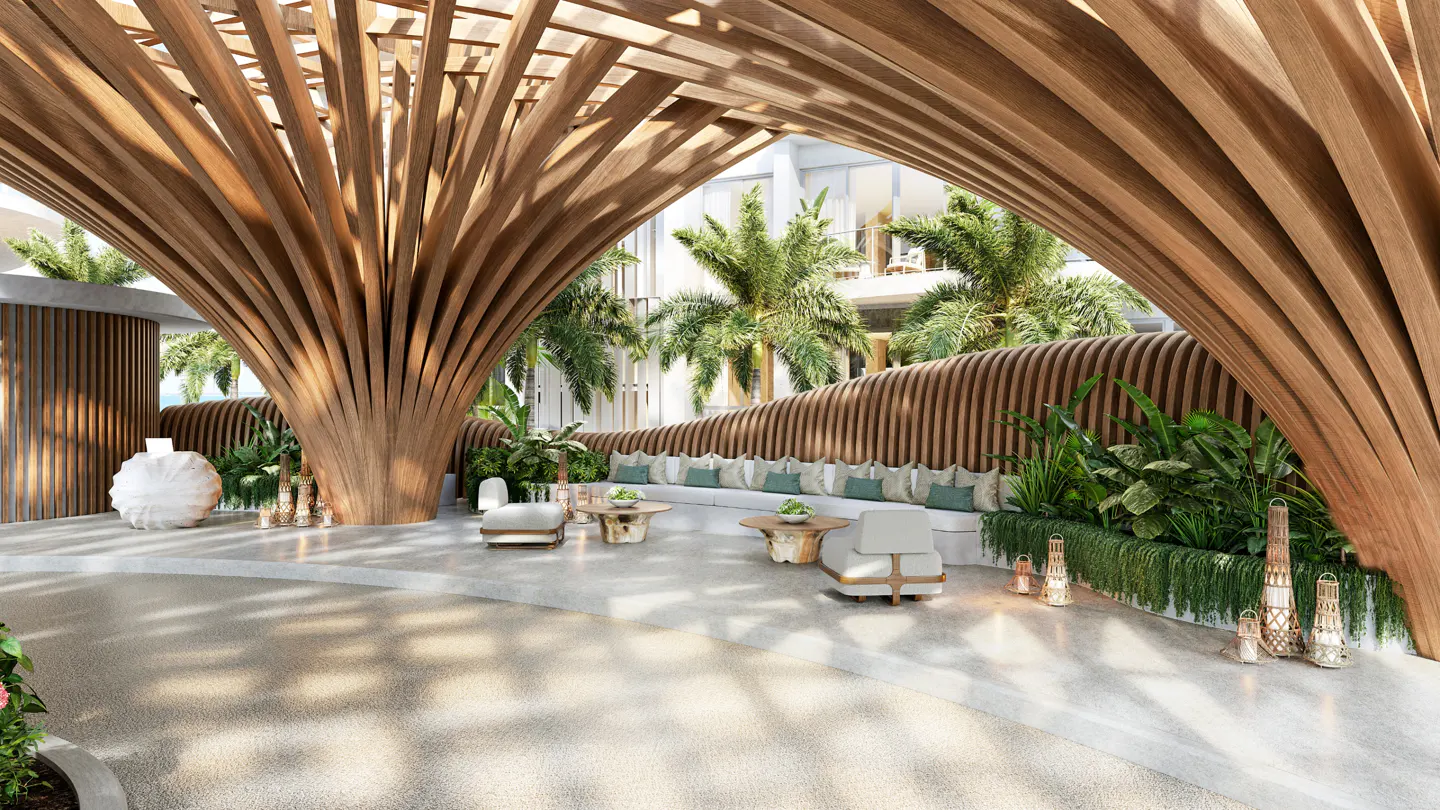 Lobby area with a wooden canopy, a long white sofa with green pillows, and tropical plants.