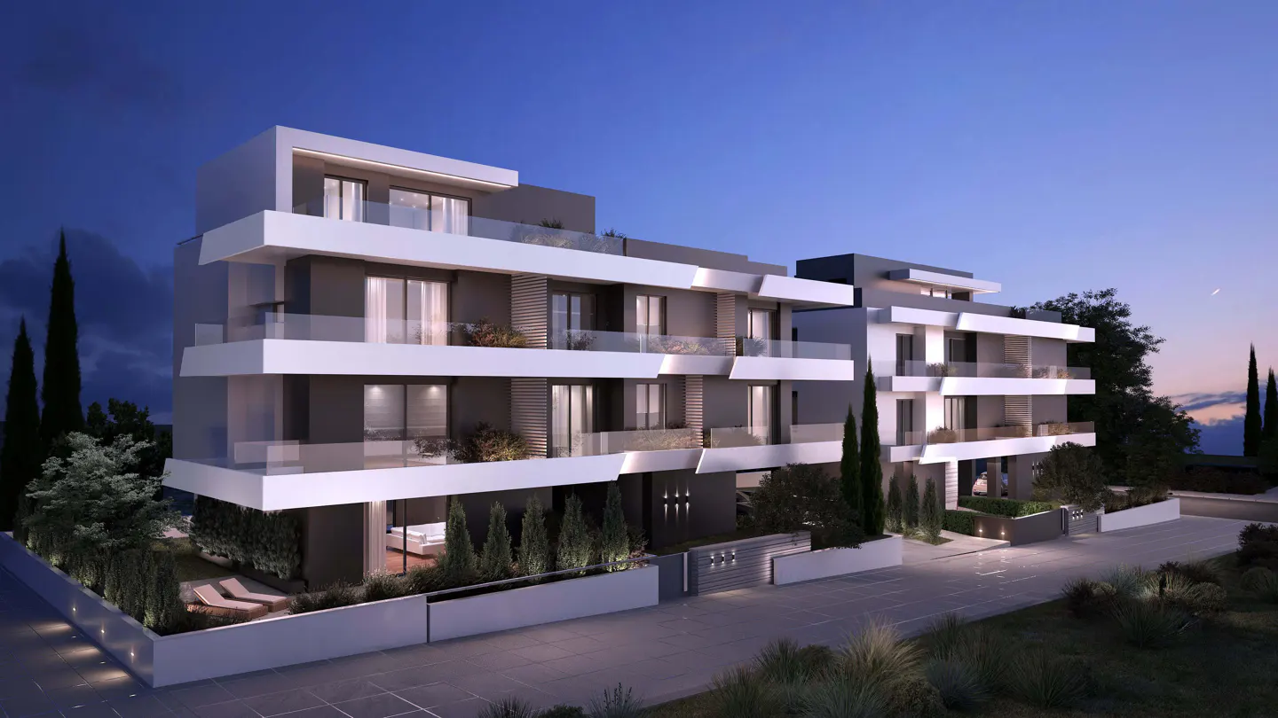 Modern, multi-story apartment building with white balconies and gray walls at dusk. Landscaped grounds with trees and shrubs.