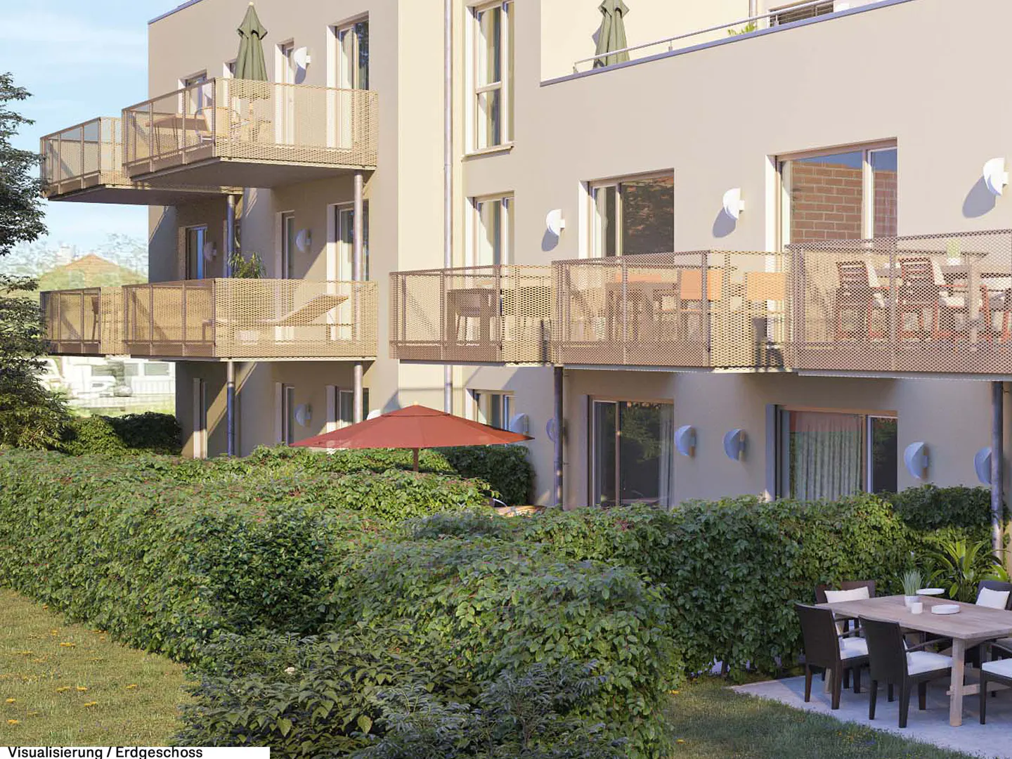 Modern apartment building exterior with balconies, a ground-floor patio, a red umbrella, and a lush green hedge.