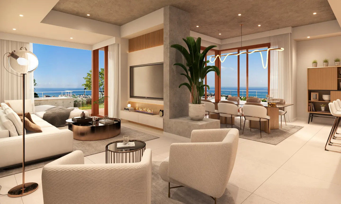 A bright, modern living and dining area with a view of the ocean. White sofa, chairs, dining table, and a large potted plant are visible.
