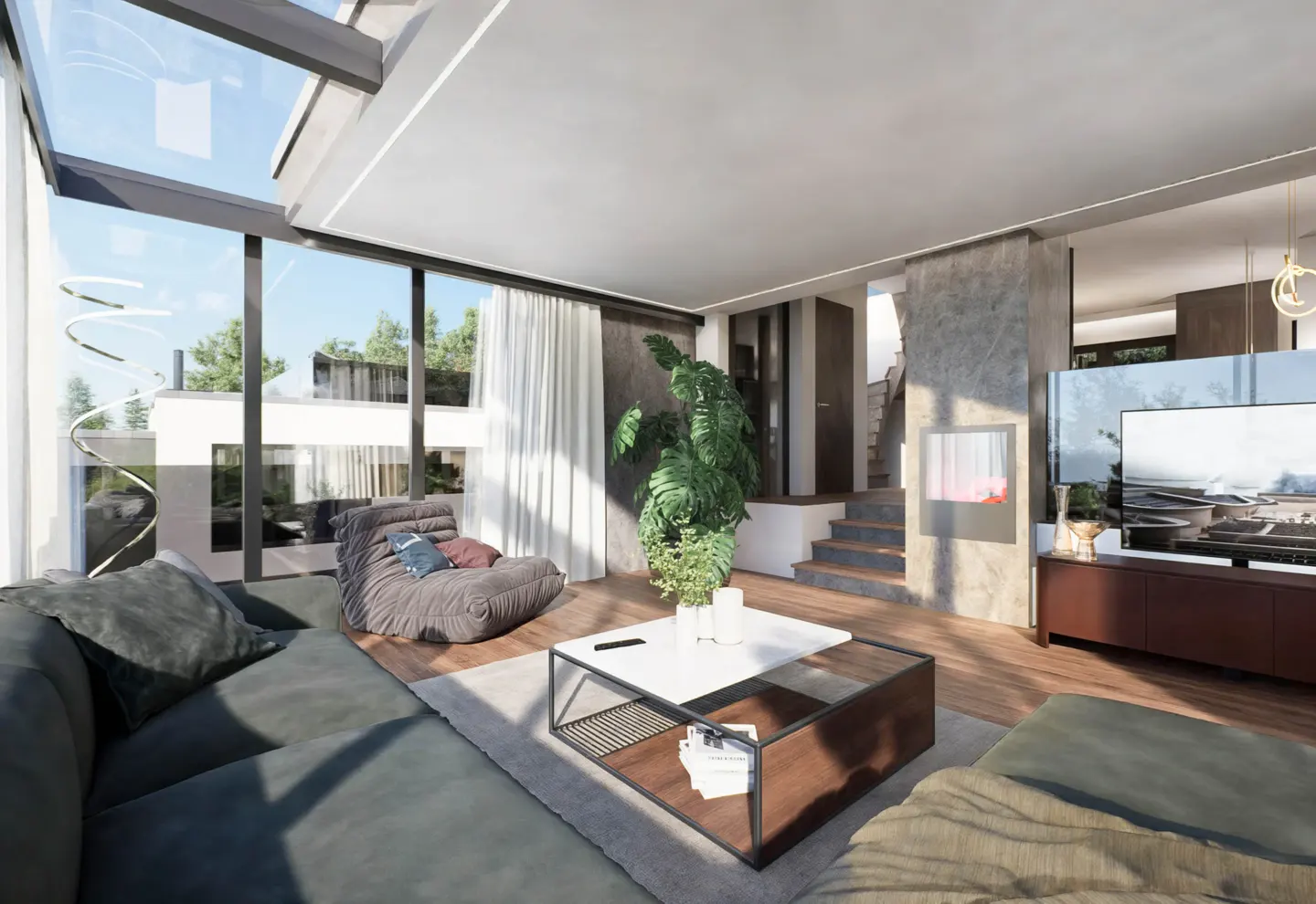 Bright living room with a gray sectional sofa, a modern coffee table, and a large window with natural light. A staircase is visible in the background.