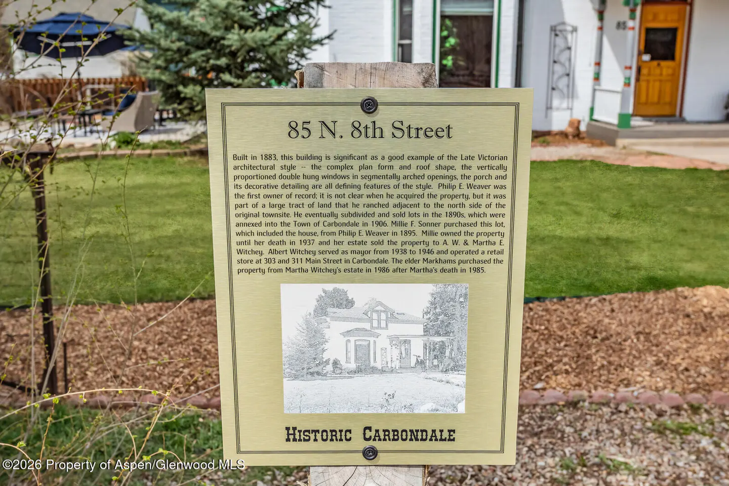 A historical marker for 85 N. 8th Street in Carbondale, with text and a vintage photo of the house.