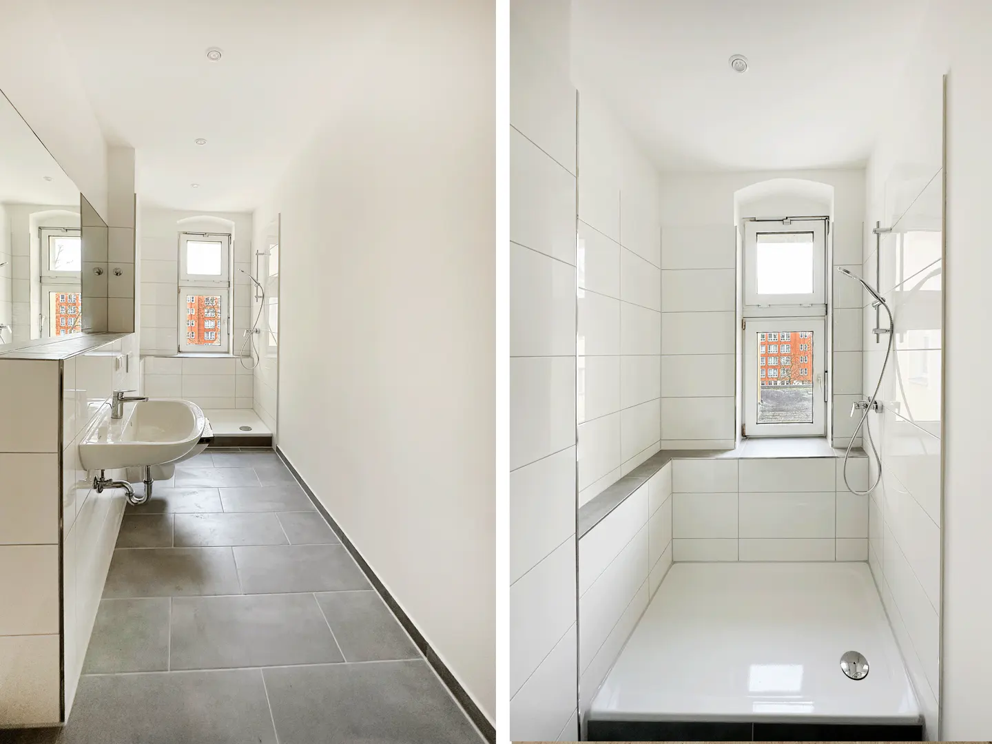 Modern bathroom with white walls, grey floor tiles, a wall-mounted sink, and a walk-in shower with white tiled walls.