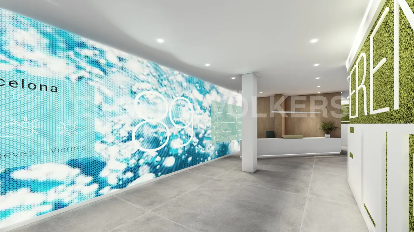 Real estate office interior with a blue patterned wall, reception desk, and a green moss wall with white lettering.
