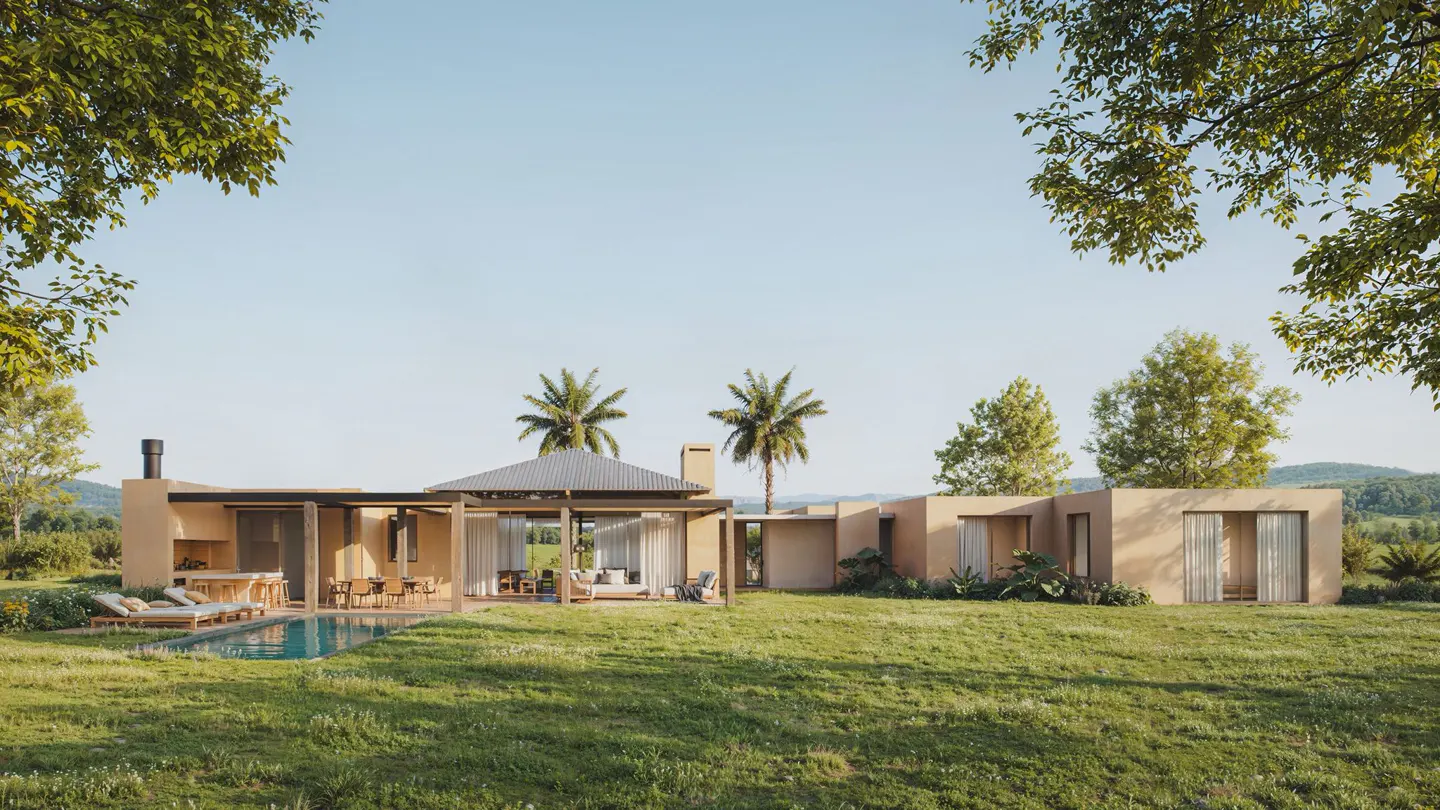 Modern tan home with a pool, lounge chairs, and outdoor dining on a green lawn with palm trees under a blue sky.