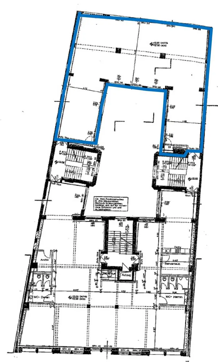 Blueprint of a building floor plan with blue outline, showing stairs, bathrooms, and dimensions.