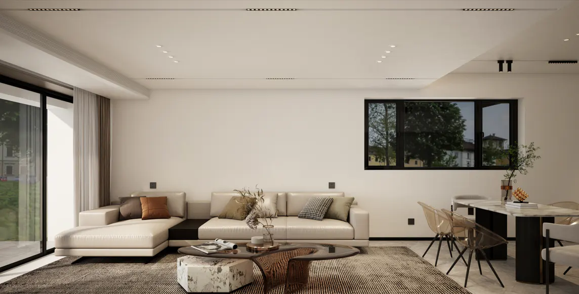Bright living room with a beige sectional sofa, marble coffee table, and dining set near a window.