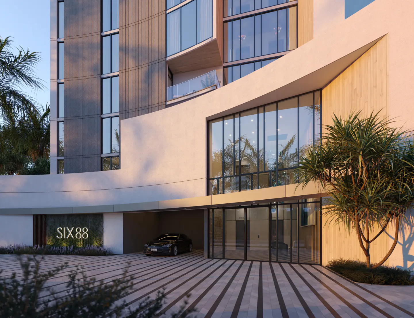 Exterior view of SIX88 building with a car parked in the garage and palm trees in the background.