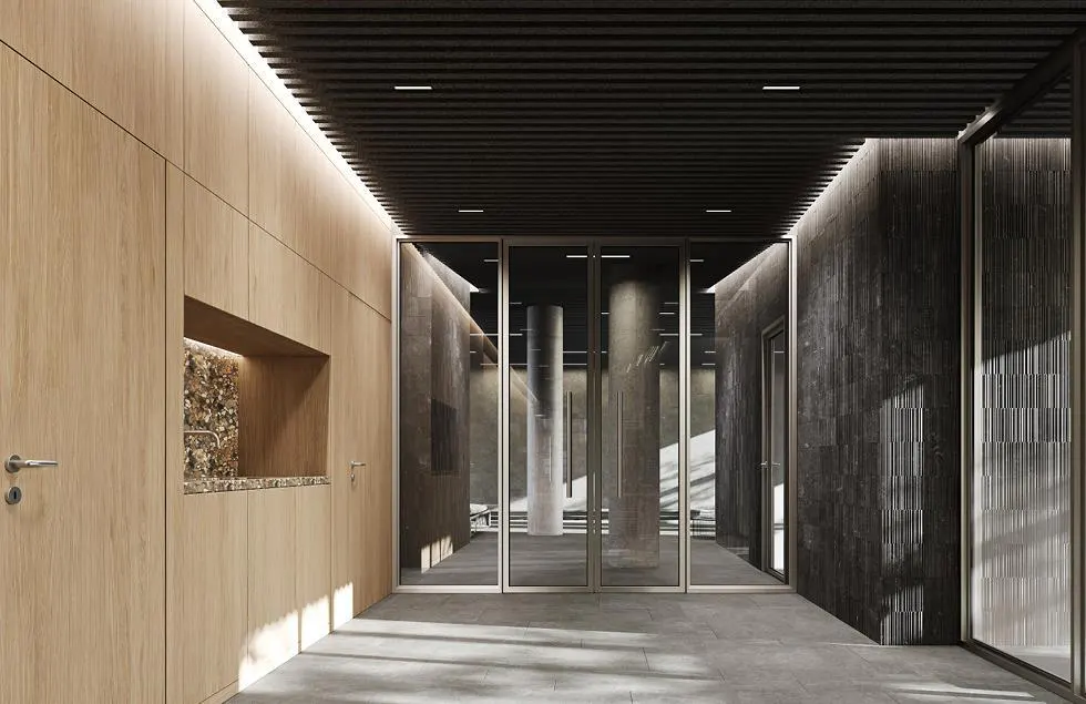 Hallway with light wood paneling, a sink, and glass doors leading to a room with concrete pillars.