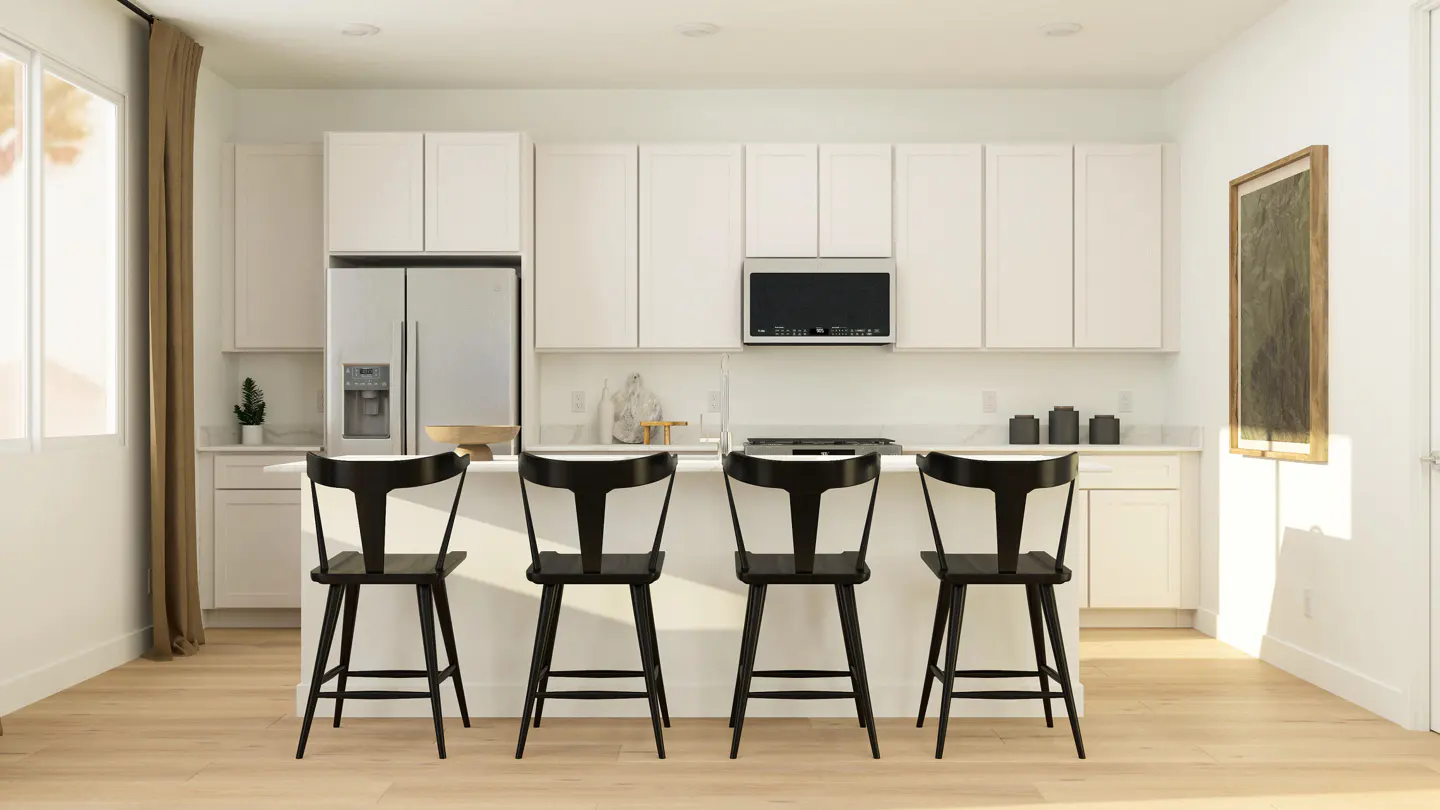 Bright kitchen with white cabinets, stainless steel appliances, and four black bar stools at the island. A framed picture hangs on the wall.