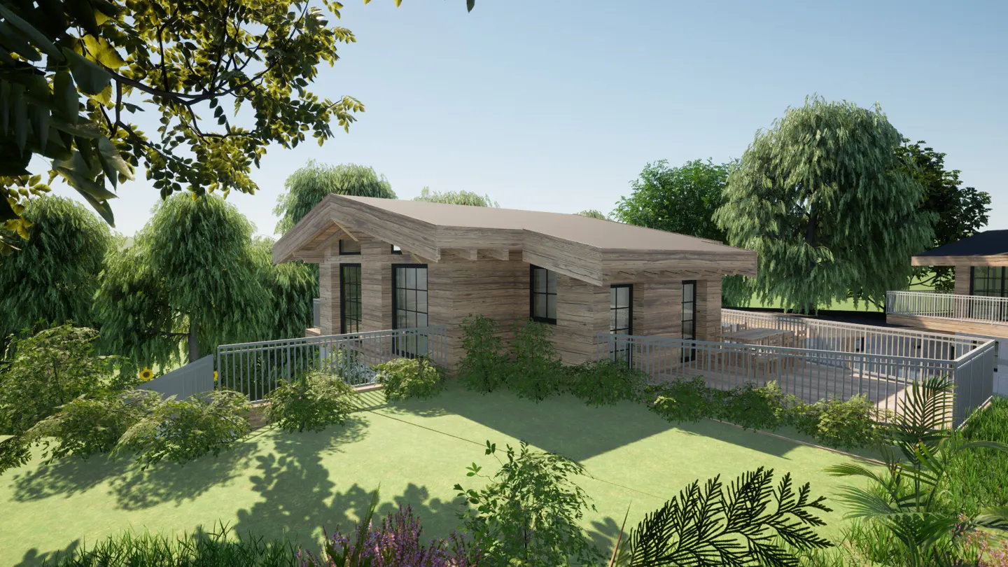 Exterior view of a modern, wood-sided cabin with a metal railing deck, surrounded by lush green trees and grass.