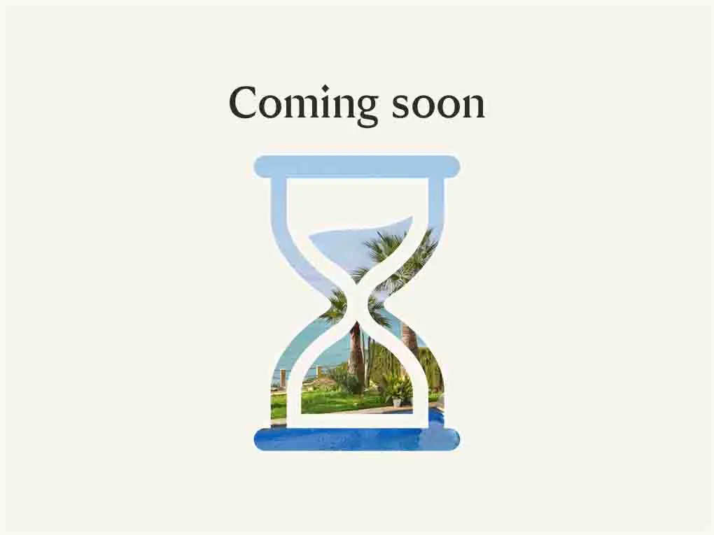 "Coming soon" text above a blue hourglass filled with a beach scene featuring palm trees and ocean views.